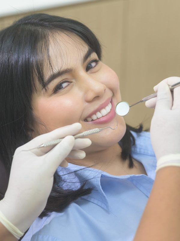 Young woman having teeth examined by dentist in dental clinic, teeth check-up and Healthy teeth concept